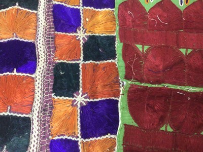 Lot 2184 - A selection of antique Pakistani embroidery items, vibrant silk floss darning stitches and chain stitches on hand woven cotton. Including women's top and top front, tea cosy, pairs of panels...