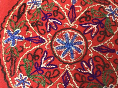 Lot 2184 - A selection of antique Pakistani embroidery items, vibrant silk floss darning stitches and chain stitches on hand woven cotton. Including women's top and top front, tea cosy, pairs of panels...