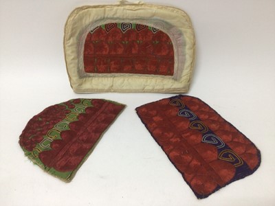 Lot 2184 - A selection of antique Pakistani embroidery items, vibrant silk floss darning stitches and chain stitches on hand woven cotton. Including women's top and top front, tea cosy, pairs of panels...