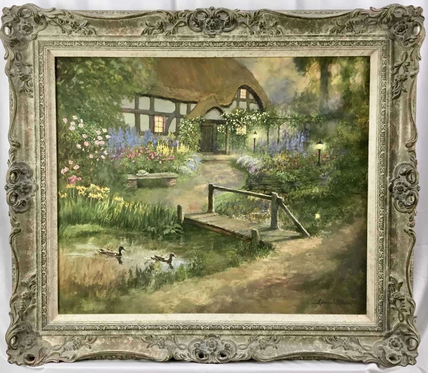 Lot 2 - Norman Coker (Contemporary) oil on canvas- Twilight cottage with wooden bridge, 64cm x 54cm