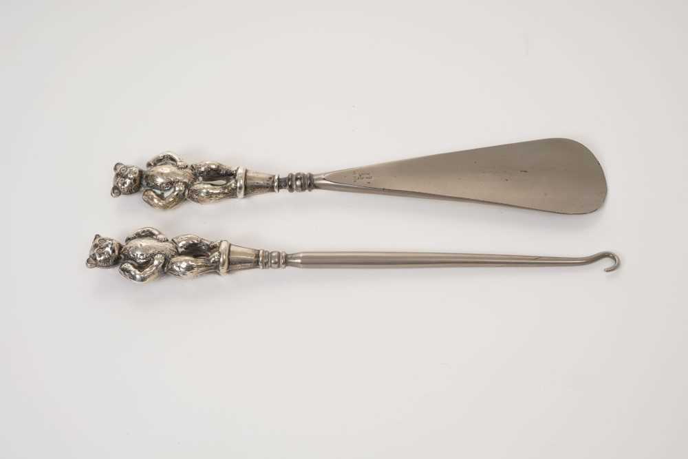 Lot 335 - Edwardian silver teddy bear mounted shoe horn and button hook