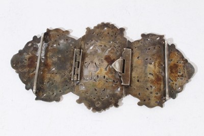 Lot 43 - Thai white metal  buckle with figure and foliate scroll pierced decoration