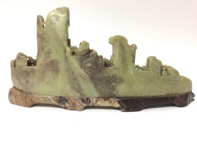 Lot 21 - Good 19th century Chinese soapstone carving of a mountain range with pagodas to the wooden landscape below, on pierced base, 43cm long