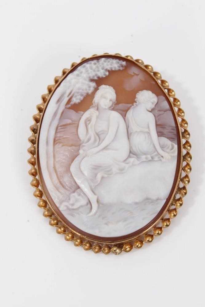 Lot 28 - Carved shell cameo depicting two seated female figures, in 9ct gold brooch mount