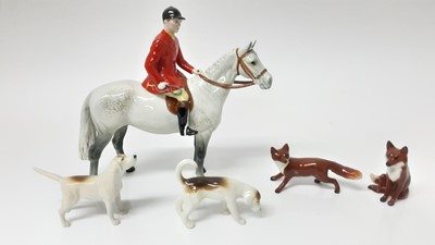 Lot 74 - Beswick Huntsman (style two) model no. 1501, designed by Arthur Gredington, 21cm high, together with two hounds and two foxes (5)