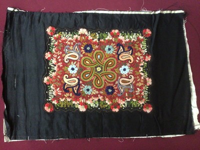 Lot 2187 - A black satin panel with a central appliqued panel with fine floral embroidey.  Black satin panels, two with silk thread embroidery and two with printed floral design.  Handstitched chevron patchwo...