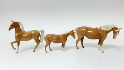 Lot 77 - Three Beswick Palamino horses including (Prancing Arab Type), model no. 1261, designed by Arthur Gredington, 17cm high