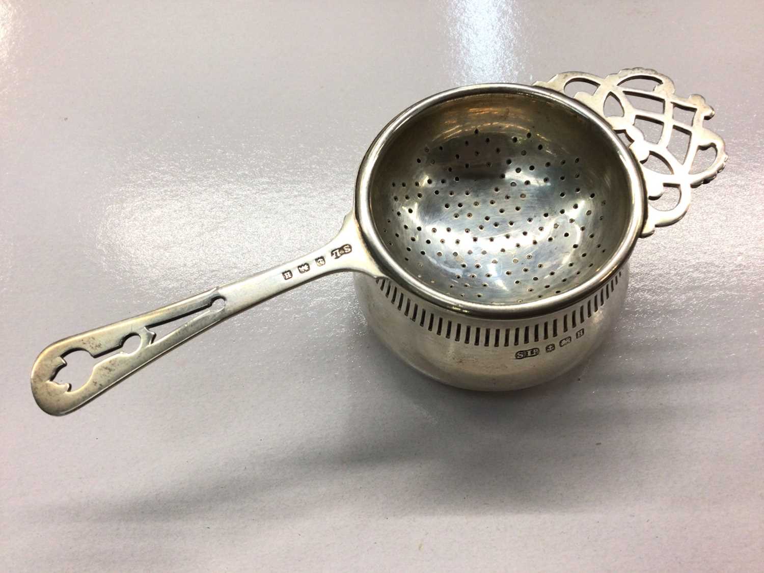 Lot 650 - 1930's silver tea strainer and stand