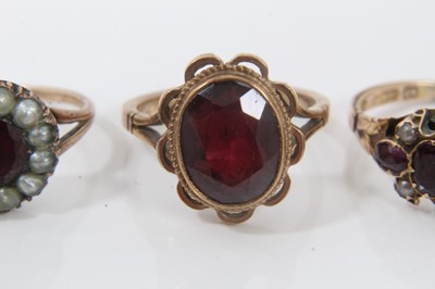 Lot 74 - Antique yellow metal garnet and seed pearl ring, two other 9ct gold garnet rings and yellow metal green hard stone ring (4)