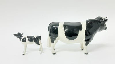 Lot 91 - Beswick Friesian Cow - CH Claybury Legwater, model no. 1362A, designed by Arthur Gredington, 11.9cm high, together with Friesian Calf (2)