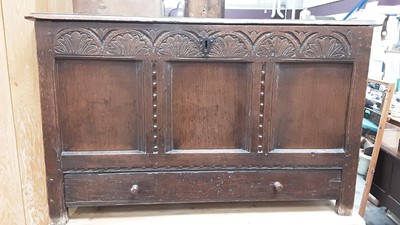 Lot 884 - 18th century elm coffer of rectangular form with rising lid, carved frieze and three panelled front with single drawer below, on block feet