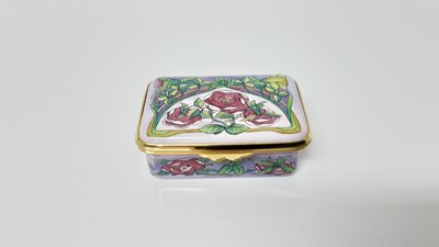 Lot 1202 - Moorcroft enamel trinket box with floral decoration on pink ground