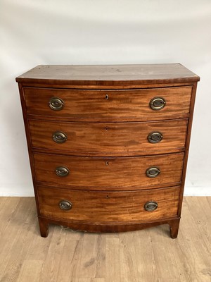 Lot 1027 - Regency  mahogany bow front chest of four long drawers with oval brass handles, on bracket feet