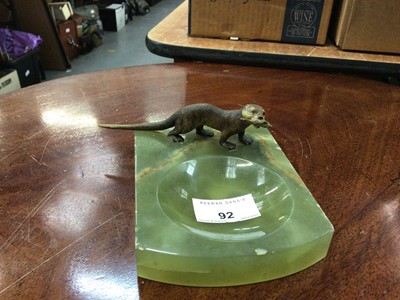 Lot 92 - Onyx dish surmounted by a cold painted otter holding a fish