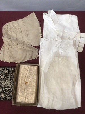 Lot 2194 - Box of Victorian and later textiles including woman's ruched bonnet, three embroidered / pulled thread aprons white kid gloves, green leather gaunlet style gloves, oversized floral embroidered draw...