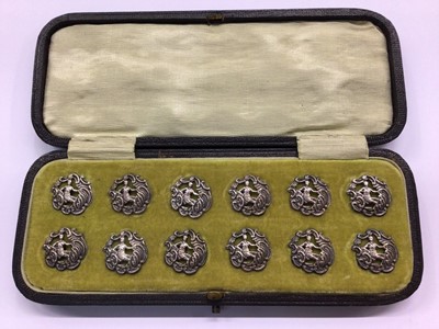 Lot 665 - Set of twelve silver buttons, in fitted case