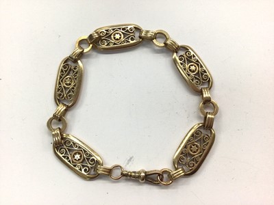 Lot 666 - 9ct gold oval panel bracelet with star and pierced scroll design