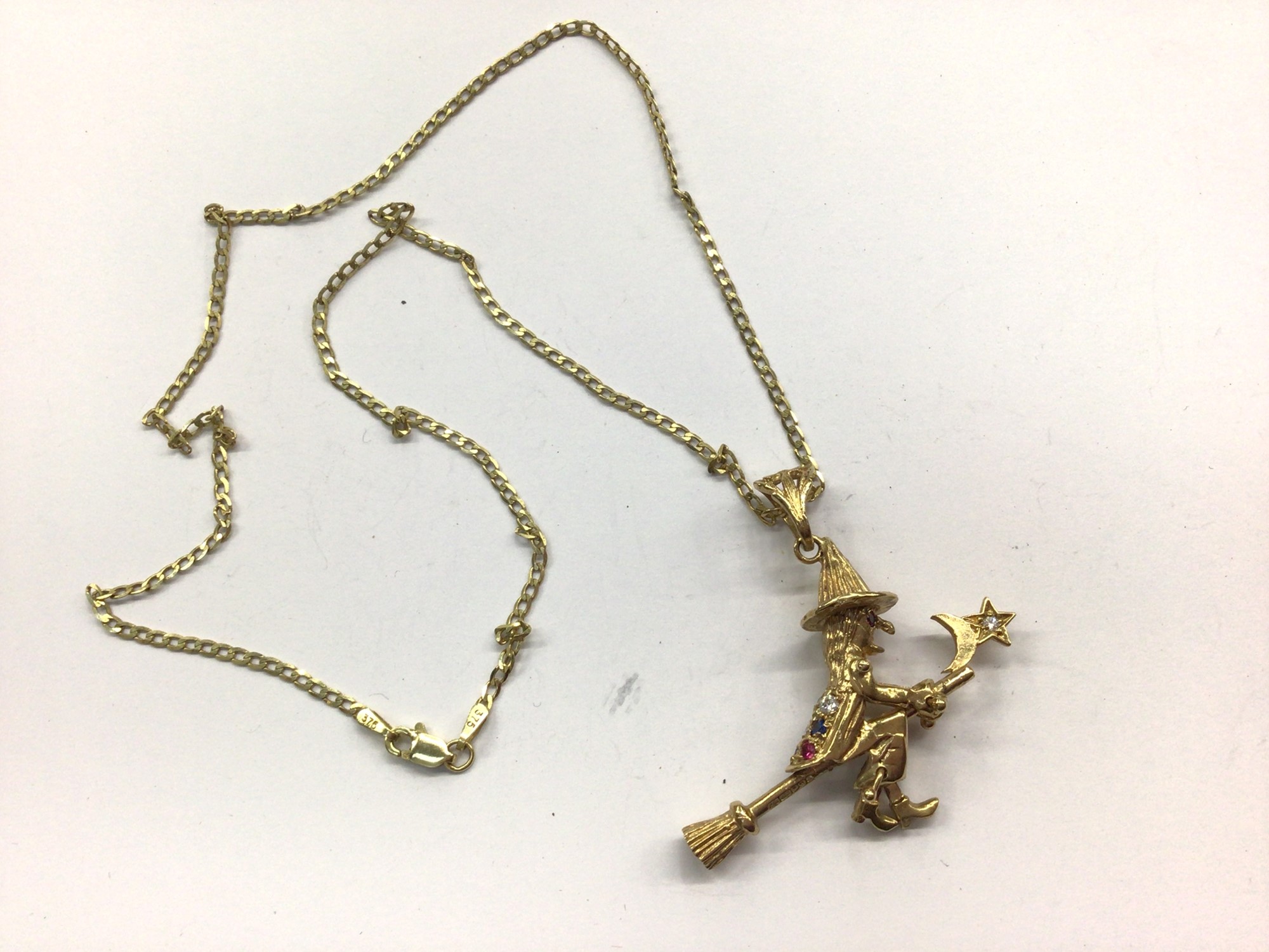 9ct gold gem set witch pendant on 9ct gold