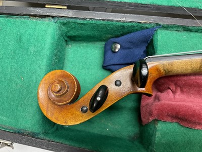 Lot 2356 - Late 19th / early 20th century violin with two bows, cased