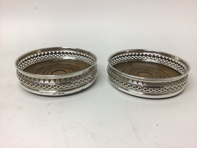 Lot 726 - Pair of sterling silver wine coasters