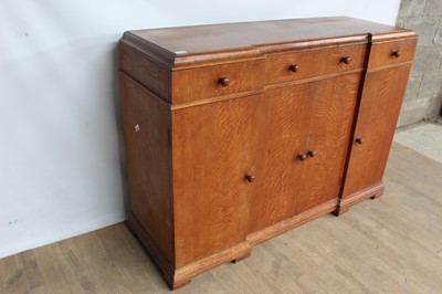 Lot 1443 - Suite of 1930s oak furniture in the manner of Heals, including refectory style table and sideboard