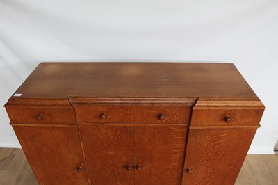 Lot 1443 - Suite of 1930s oak furniture in the manner of Heals, including refectory style table and sideboard