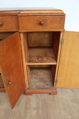 Lot 1443 - Suite of 1930s oak furniture in the manner of Heals, including refectory style table and sideboard