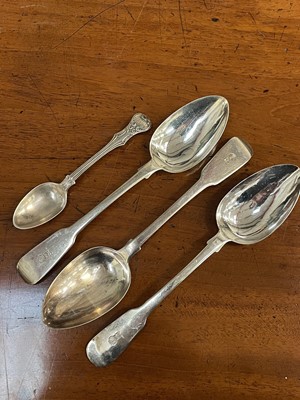 Lot 700 - Three William IV silver fiddle pattern table spoons with engraved crest and a Victorian silver teaspoon (4), 6.9ozs