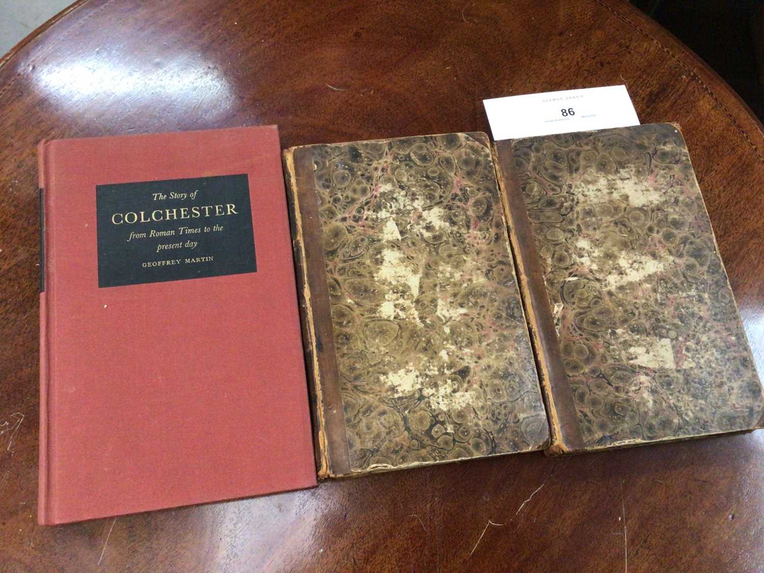 Lot 86 - Two volumes, The History and Description of Colchester 1803, half calf leather bound, together with The Story of Colchester, Geoffrey Martin (3)