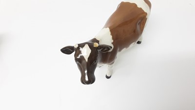 Lot 135 - Two Beswick Hereford calves, model no. 1827C, designed by Arthur Gredington, 7.6cm high, together with a an Ayrshire Cow (3)