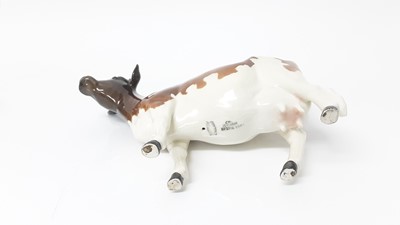 Lot 135 - Two Beswick Hereford calves, model no. 1827C, designed by Arthur Gredington, 7.6cm high, together with a an Ayrshire Cow (3)