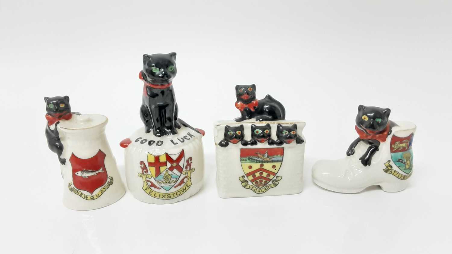 Lot 143 - Four Arcadian Crested China Black Cats - Good Luck Felixstowe, Lechlade, Newquay and Attleborough