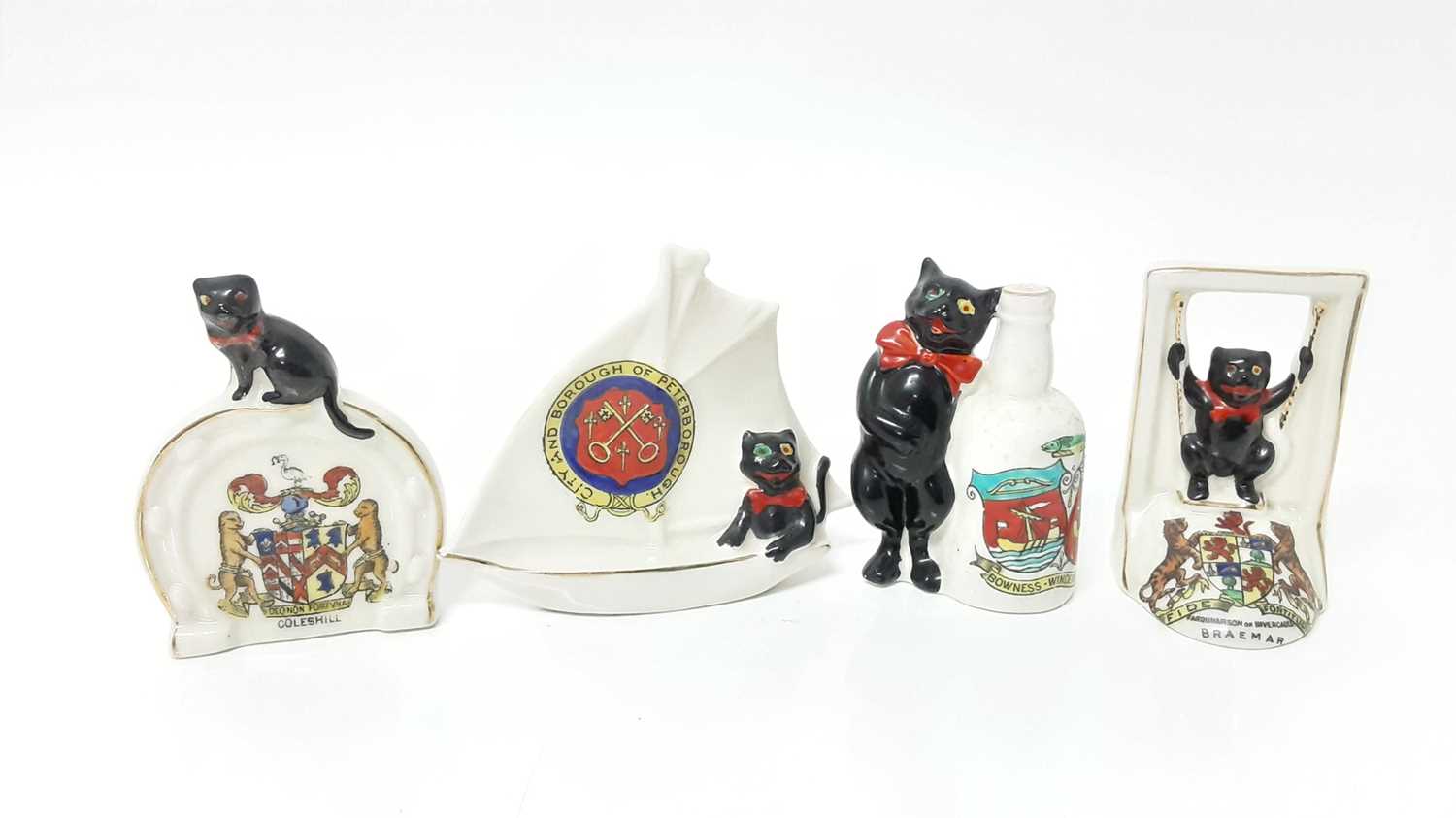 Lot 145 - Four Arcadian Crested China Black Cats - Bowness Windermere, City Borough of Peterborough, Braemar and Coleshill