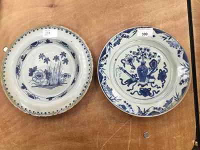 Lot 300 - 18 th century Chinese export blue and white plate decorated with precious objects and 18 th century tin glazed pottery plate (2)