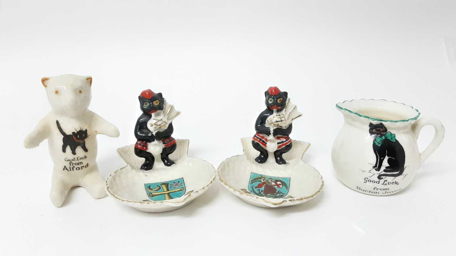 Lot 152 - Four Arcadian Crested China Black Cats including bagpipers - Barnard Castle, Alnwick, Alford and Burton Joyce