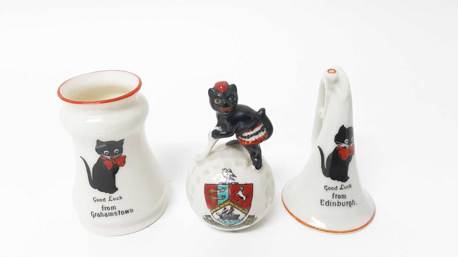 Lot 153 - Two Willow Art Crested China Black Cats - one on top of a golf ball, Broadstairs, the other in the form of a bugle, Good Luck from Edinburgh, together with Disa Art Black Cat - Good Luck from Graha...