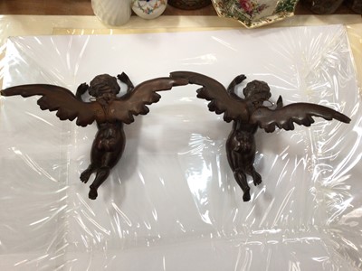 Lot 291 - Pair of 19th century carved wood winged cherubs, each 24cm across