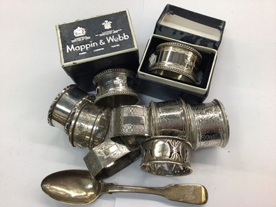 Lot 686 - Nine silver napkin rings and a silver teaspoon