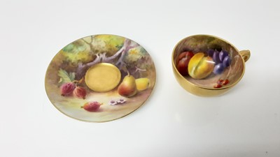 Lot 1244 - Royal Worcester cabinet cup and saucer, hand decorated with fruit, signed Rickell