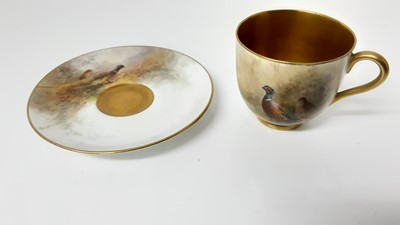 Lot 1249 - Royal Worcester cabinet cup and saucer, hand decorated with a Pheasant, signed Jas Stinton