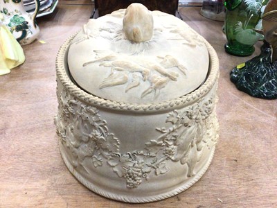 Lot 368 - Wedgwood caneware game pie dish, decorated in relief with age birds hanging from grape vines, the cover with a rabbit-form handle, complete with liner, 27cm across