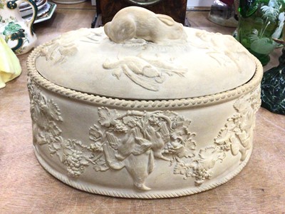 Lot 368 - Wedgwood caneware game pie dish, decorated in relief with age birds hanging from grape vines, the cover with a rabbit-form handle, complete with liner, 27cm across