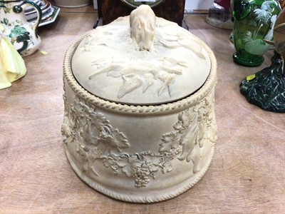 Lot 368 - Wedgwood caneware game pie dish, decorated in relief with age birds hanging from grape vines, the cover with a rabbit-form handle, complete with liner, 27cm across