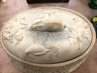 Lot 368 - Wedgwood caneware game pie dish, decorated in relief with age birds hanging from grape vines, the cover with a rabbit-form handle, complete with liner, 27cm across