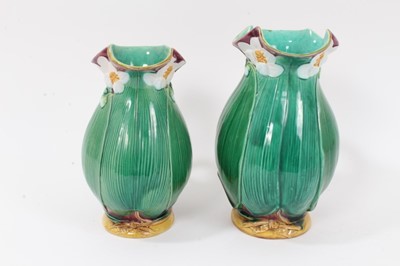 Lot 46 - Two Victorian Minton majolica jugs, moulded with large leaves and flowers, model numbers 1228, 20cm and 22.5cm high