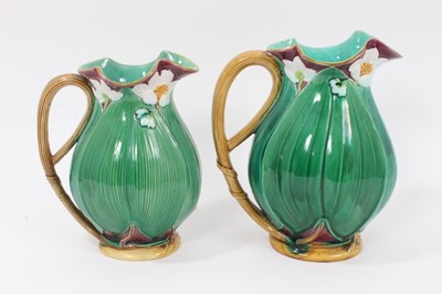 Lot 46 - Two Victorian Minton majolica jugs, moulded with large leaves and flowers, model numbers 1228, 20cm and 22.5cm high