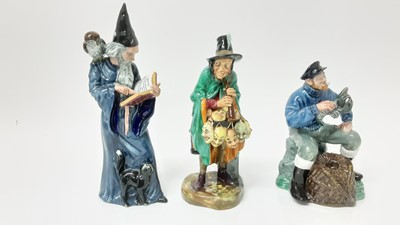 Lot 1324 - Three Royal Doulton figures: The Wizard HN 2877, The Mask Seller HN 2103, and The Lobster Man HN 2317