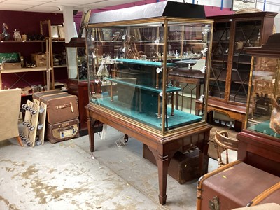 Lot 846 - Good quality brass bound glass jewellers display cabinet of large proportions, on mahogany square taper legs and spade feet, 174cm wide, 77cm deep, 206cm high