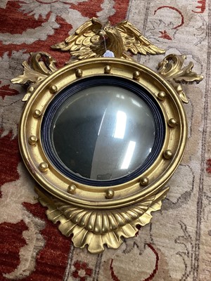 Lot 1435 - Regency-style gilt convex wall mirror with eagle mounts