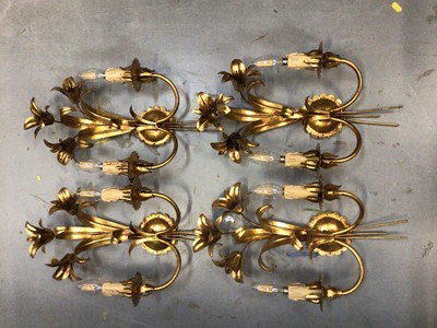 Lot 630 - Four gilt Lily style electric twin branch wall sconces, with candle drip fittings for bulbs